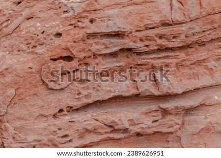 Close up of desert boulder with holes and striations. Copy space