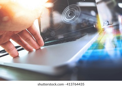 Close Up Of Designer Hand Working With Laptop Computer On Wooden Desk As Responsive Web Design Concept