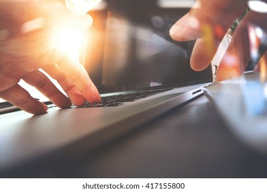 Close Up Of Designer Hand Working With Laptop Computer On Wooden Desk As Responsive Web Design Concept