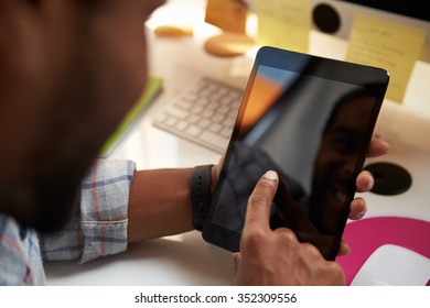 Close Up Of Designer Using Digital Tablet At Desk
