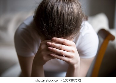 Close Up Desperate Woman Sitting On Chair Crying At Home. Depressed Frustrated Millennial Female Having Emotional Problems, Fears, Worried And Hopeless. Psychological Therapy, No Energy, Lack Of Sleep