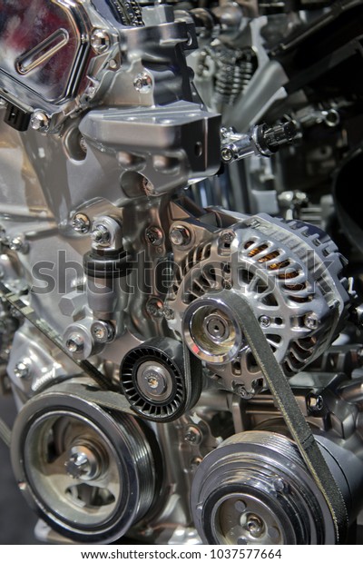 Close up detail of an automotive engine on display\
at an auto show.