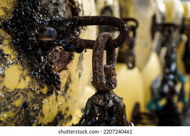 Close Up Detail Of Chains On The Side Of A Rusty Water Tank With Soft Focus Background