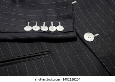 Close Up Detail Of Custom Made Two Button Jacket With Pinstripe Pattern Fabric Five Sleeves Buttons And Front Pocket , Professional Tailor Concept.
Bespoke Jacket ,top View.
 