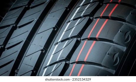 CLOSE UP DETAIL OF GROOVES TIRE TREAD FOR CAR GRIP ON THE ROAD FOR SAFETY. VEHICLE MAINTENANCE IN WORKSHOPS. - Powered by Shutterstock