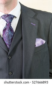 Close Up Detail Image Of Bespoke Tailored Grey Business Suit With Purple Tie, Waistcoat And Shirt