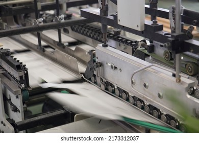 Close Up Detail Of Industrial Machinery At Work In A Production Line, Conveyor Belts Are Visible, No People Are Present.