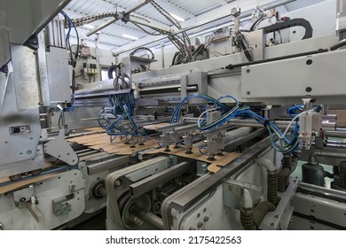 Close Up Detail Of Industrial Machinery At Work In A Production Line, Conveyor Belts Are Visible, No People Are Present.