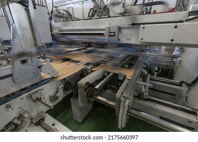 Close Up Detail Of Industrial Machinery At Work In A Production Line, Conveyor Belts Are Visible, No People Are Present.