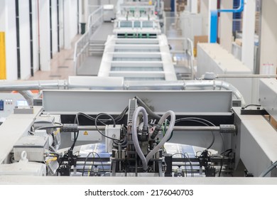 Close Up Detail Of Industrial Machinery At Work In A Production Line, Conveyor Belts Are Visible, No People Are Present.