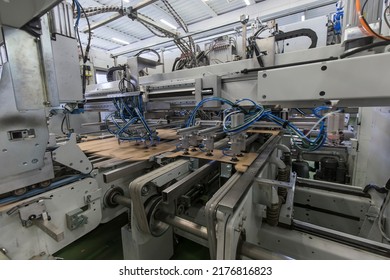 Close Up Detail Of Industrial Machinery At Work In A Production Line, Conveyor Belts Are Visible, No People Are Present.