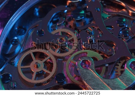 Close up detail of a macro clockwork inside a shiny iron wristwatch with sapphire rear glass bottom.