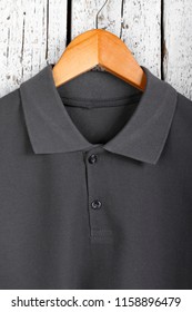 Close Up Detail Mens Dark Grey Polo Shirt Short Sleeve Front View On Rustic White Wood Background. Design Sweatshirt Mockup For Print.