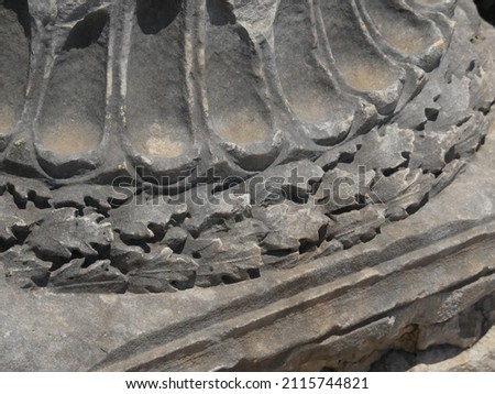 Close up detail of oak-leaf pattern on an ancient greek or roman fluted column, probably doric style. 