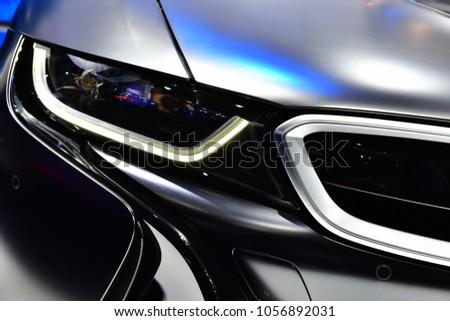 Close up detail on one of the LED headlights super car.