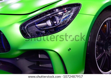 Close up detail on one of the LED headlights super car.