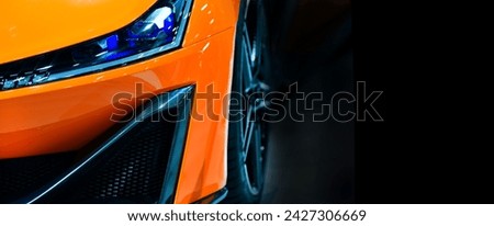 Close up detail on one of the LED headlights orange sport car.