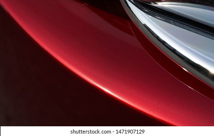 Close Up Detail Of Red Metallic Paint Coating Car Body