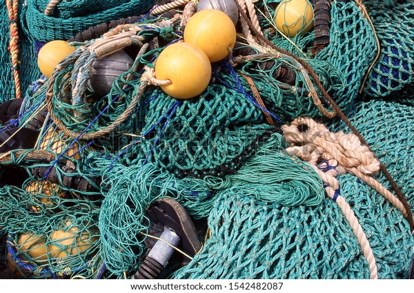 Close up detail of rope and netting of commercial\
fishing nets