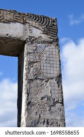 Close Up Detail of Rough Concrete Pillar against Blue Cloudy Sky 