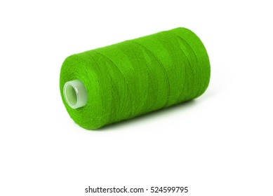 Close up detail still life of light green spool of thread isolated on white background copy space - concept fashion DIY clothing sewing handicraft design handmade needlework tradition