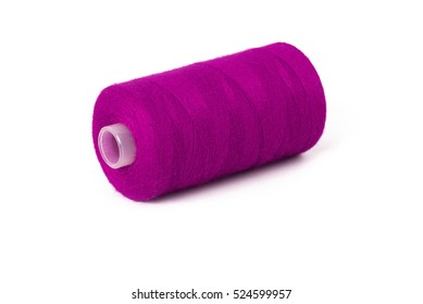 Close up detail still life of magenta spool of thread isolated on white background copy space - concept fashion DIY clothing sewing handicraft design handmade needlework tradition