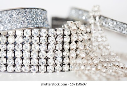 Close Up Detail Still Life View Of Exclusive And Luxurious Diamond Bracelets, Engagement Rings And Earrings. A Multiple Quality Diamond Detail Jewelry Shining And Sparkling With Light, Interior.