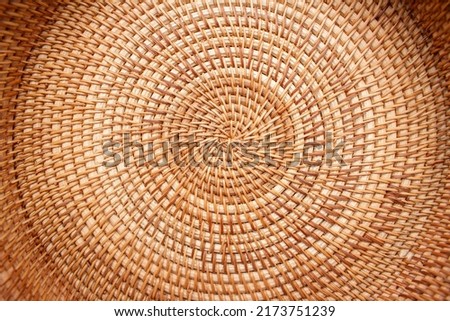 Close up detail view of a wicker basket weave with natural materials