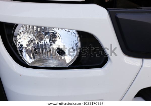 Close up detail of\
white truck headlight