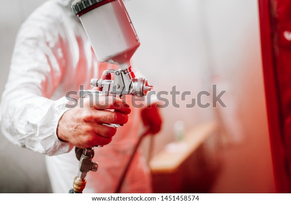 close up details of industrial worker, mechanic\
engineer painter painting a\
car