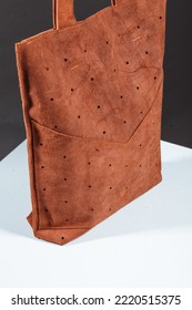 Close Up Details Of Orange Women's Genuine Thick Leather Shopper Bag Isolated Over Black Background. Minimalist Sustainable Fashion Accessories. Luxury Stylish Large Female Bag For Shopping Everyday