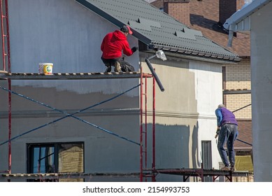 close up details of painting walls, industrial worker using roller and other tools for painting walls of new house