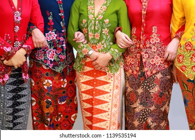 Close up details shot of southeast Asian woman in traditional Malay batik kebaya dress.
