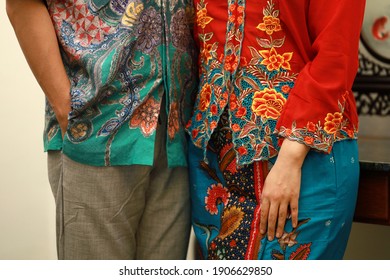 Close Up Details Shot Of Southeast Asian Man And Woman In Traditional Malay Batik And Kebaya Dress. Selective Focus Image.