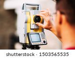 Close up details of surveyor engineer working with total station theodolite and gps system