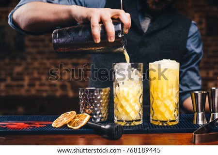 Similar – Image, Stock Photo Detail of a bartender opening a bottle of beer using a bottle opener at a bar counter.