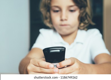 Close Up Of A Diabetic Child Is Watching A Glucometer Screen. Child Diabetes Concept