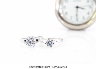 Close up Diamond gem wedding rings with watch on white  background, Jewelry wedding diamond rings on white background