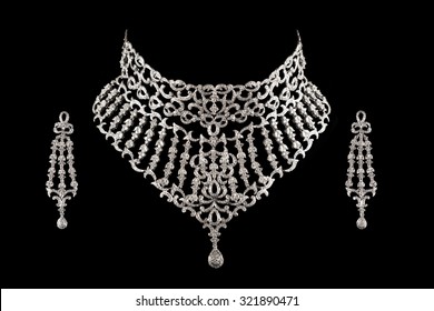 Close Up Of Diamond Necklace On Black Background With Diamond Earrings.