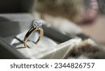 Close up of diamond ring with sunlight and shadow background. Love, valentine, relationship and wedding concept. Soft and selective focus.
