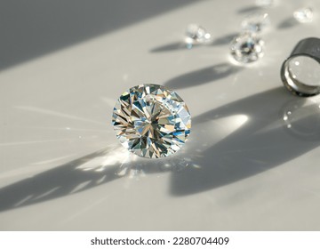 Close up of diamonds of different cuts and sizes on light background with shadows. - Shutterstock ID 2280704409