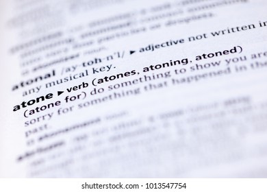 Close up to the dictionary definition of Atone