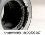 Close up of a digital camera lens mount with electronic contacts. Precision photography equipment highlighting interchangeable lens technology and optical engineering.