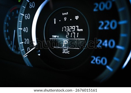 Close up of digital car dashboard odometer showing 173,297 km mileage, trip meter, parking gear indicator and 30 Celsius temperature display, automotive instrument cluster and vehicle data concept