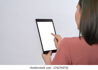 Close up digital tablet computer with isolated screen in business woman hands on white background free from copy space.