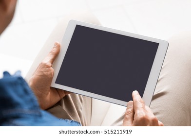 Close Up Of Digital Tablet Screen While Man Working On It. Young Businessman Switching On Tablet To Start His Work. Young Man Looking At A Blank Black Screen Of Tablet.