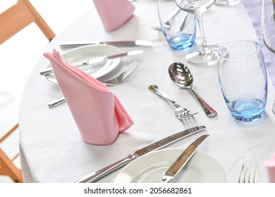 Close Up Of Dinner Place Setting  At Formal Dinner With Pink Napkin