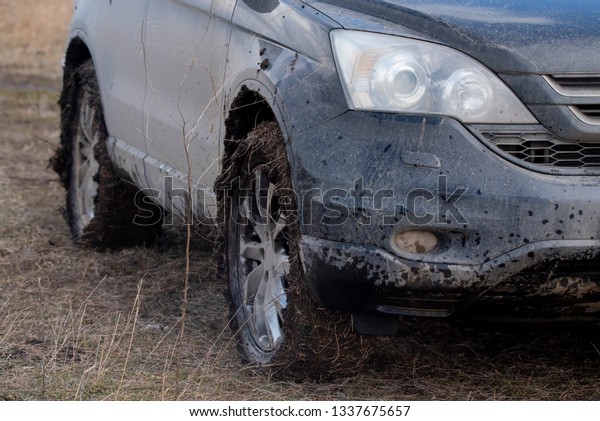 Close up dirty car\
with dry mud on tires
