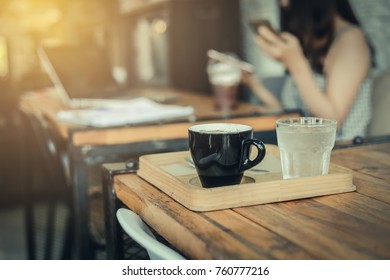 Close Up Dirty Coffee Cup With Spoon And Dish Beside Flower Bouquet In Office On Coffee Break Time With Blurry People Background