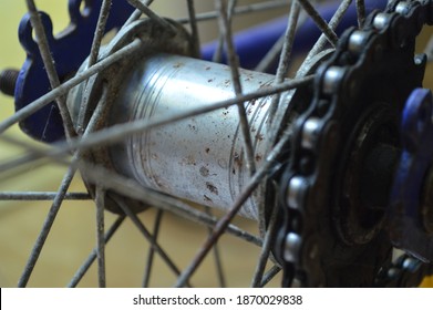 A Close Up To The Dirty Cogset Of A Blue Bike.